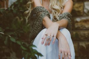 white woman with her hands crossed with a lot of rings